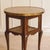 A round side table in an orientalist style, European-made between 1900 and 1920, whose engraved copper top rests on a...