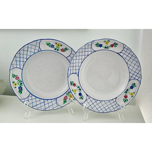 4‑piece Herend porcelain set in the Lattice Hill pattern. Hand-painted in Hungary with floral sprays and a lattice border....