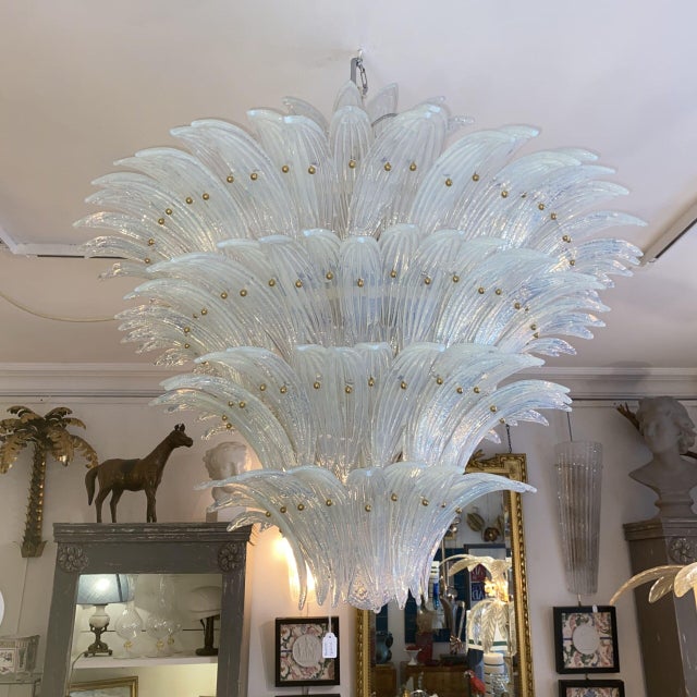 Five tiers in the shape of an inverted cone, topped with a cluster of leaves and a glass sphere at the base. The leaves...