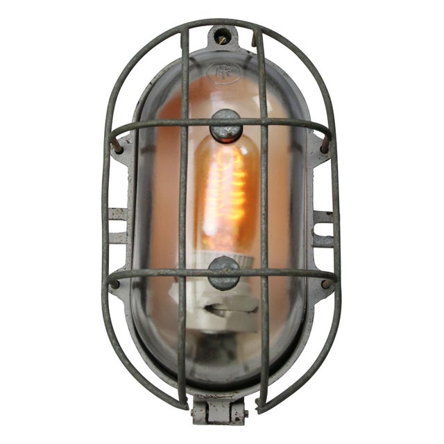 industrial wall or ceiling lamp made by Industria Rotterdam cast iron, clear glass E27/E26 This piece has an attribution...