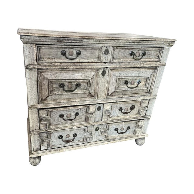 Jacobean chest of drawers hand-made in the United Kingdom in the early 1700s using oak. The chest features four inset...