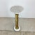 This unique vintage display pedestal features decorative turned wood column with gilt finish and marble top and base,...