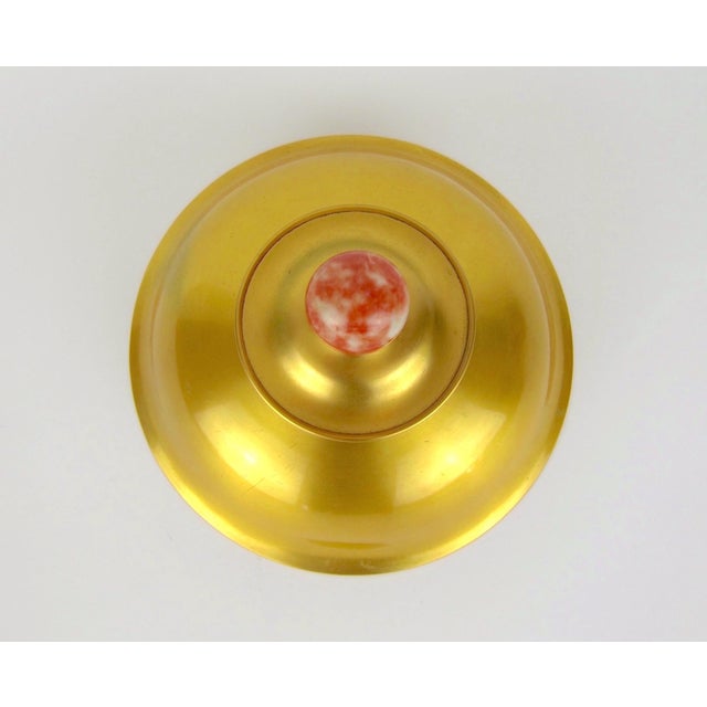 A large inkwell from the Art Deco period in gilded copper with a contrasting finial of coral and white stone by American...