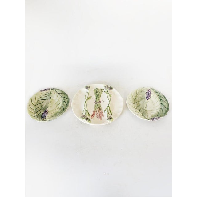 A charming set of three French majolica (barbotine) plates dating from the 1960s, decorated with raised floral motifs. Two...
