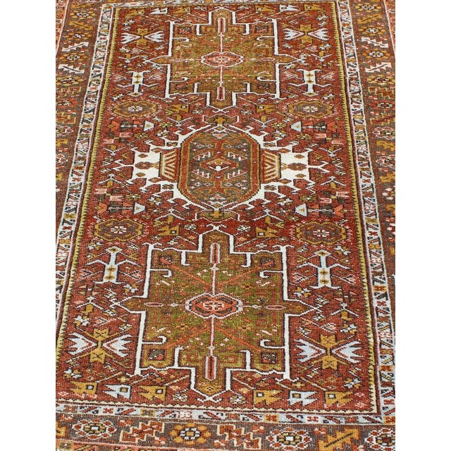 Geometric layered Medallion design antique Karadjeh rug from Persia in'rust red and olive and sharp yellow green colors,...