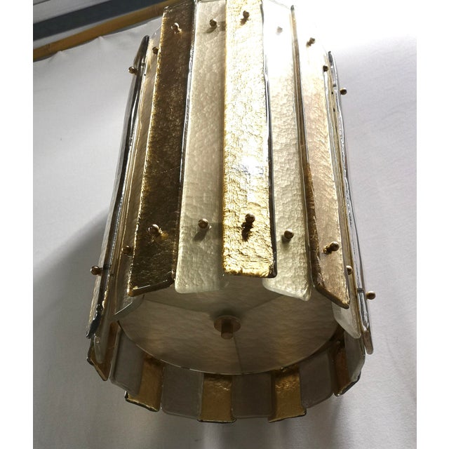 Special and very original lantern in Murano glass and brass, unique design enriched by a particular glass with a very...