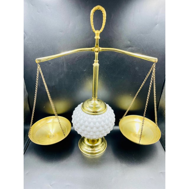 This stunning piece of Regency-style decor is as intriguing as it is beautiful. The brass and milk glass design of the...