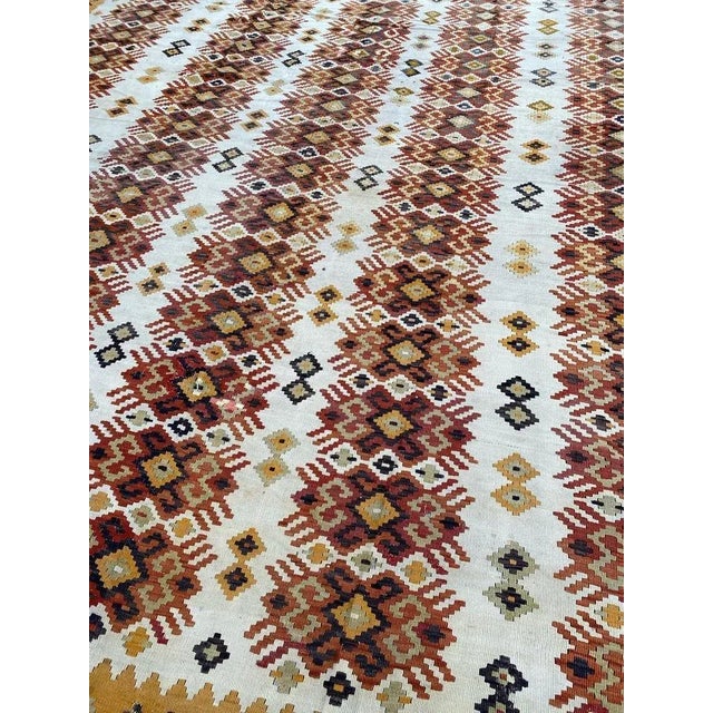 Beautiful and decorative large Kilim with a geometric design and nice colors with yellow, orange, green and dark purple,...