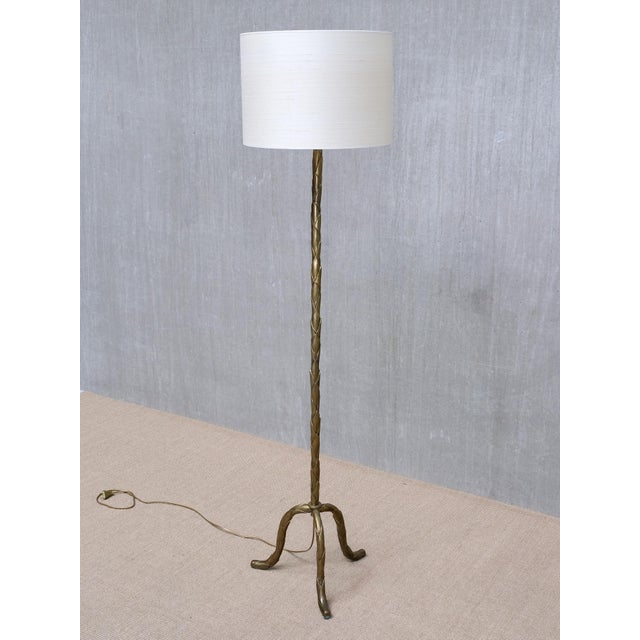 This striking floor lamp was produced by Maison Baguès in France in the 1940s. Crafted in brass, the lamp stands on an...