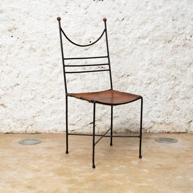 Immerse yourself in the timeless allure of mid-century modern design with the Pere Cosp Iron and Leather Chair, a...