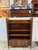 Design Plus Gallery presents an Antique Bookshelf with Empire Style. Empire style faux book-front cabinet has heads of...