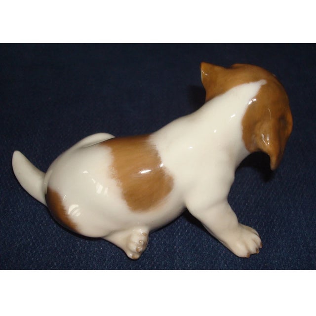 Charming and beautifully crafted, this vintage Royal Copenhagen Pointer Puppy Dog figurine captures the playful spirit and...