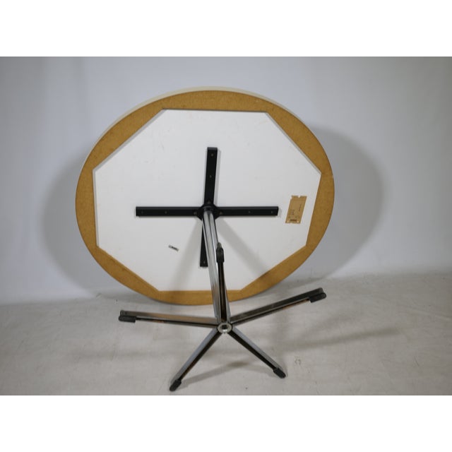 Round space-age dining table by EMU, 1970s. The table features a white tabletop and a chrome star base with a central...