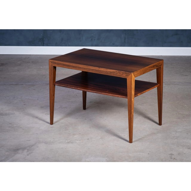 Refined rosewood side table designed by Severin Hansen and produced by Haslev Møbelfabrik in the 1950s. This piece...