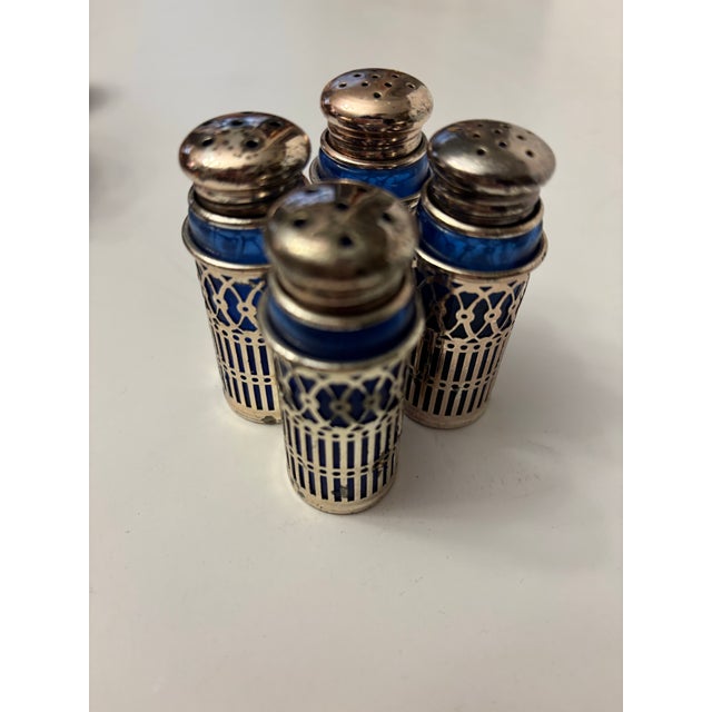 Assorted collection of Vintage silver-plated salt and pepper shakers with cobalt blue glass inserts. They are often...