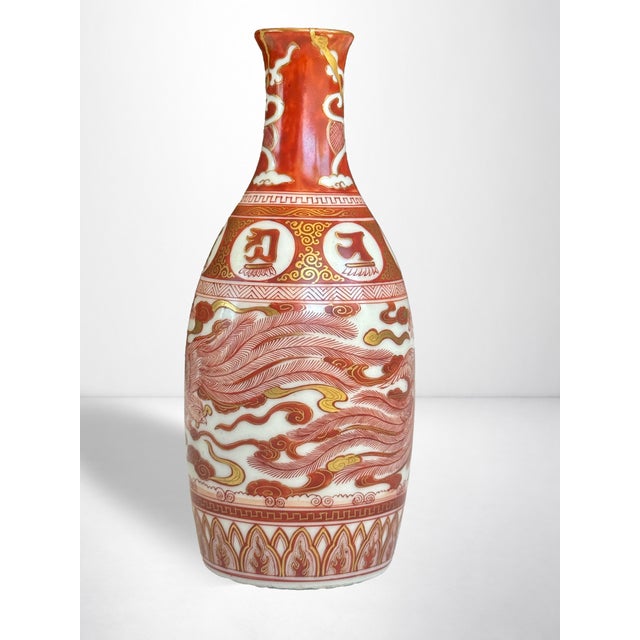 An extraordinary example of Japanese aka-e Kutani porcelain, this tokkuri (sake bottle). The style is Kinrande (金襴手 -...
