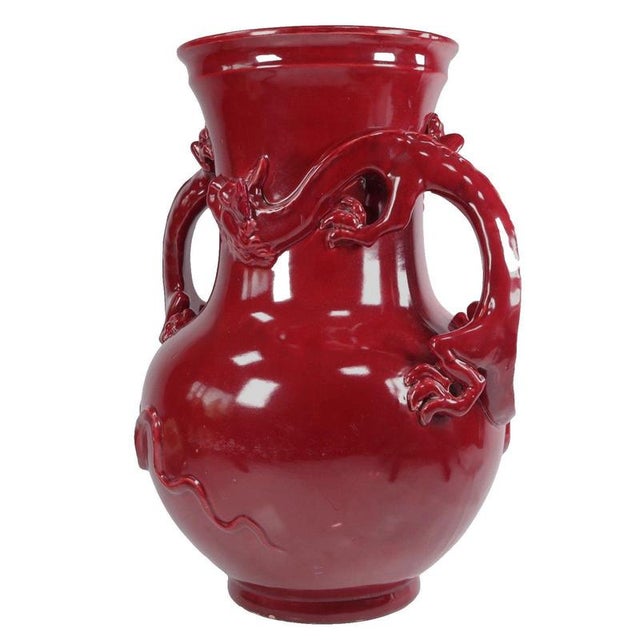 Boldly modelled dragon handles dominate the silhouette of this baluster vase, with their clawed limbs and horned heads...