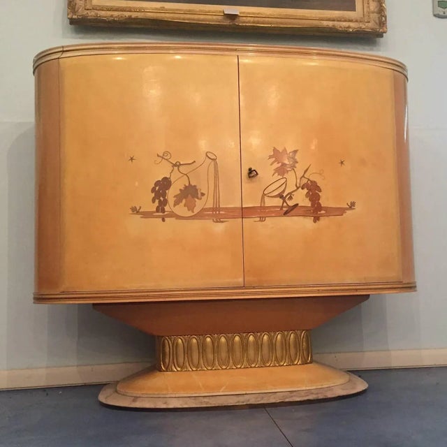 This Art Deco bar in lacquered wood parchment features inlays on the doors, a red interior with glass shelves that lit up...