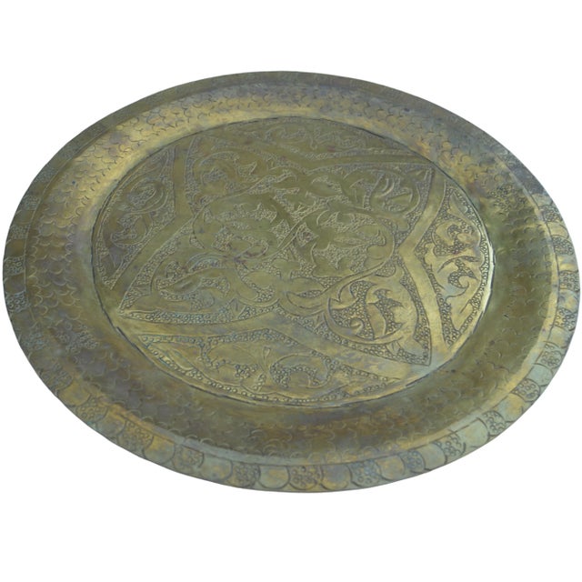Mid-Century hand-engraved and detailed Moroccan brass tray featuring ornate moorish pattern. Hook on reverse for hanging....