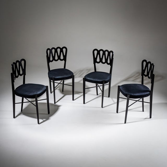 Set of four black-lacquered dining chairs featuring distinctive backrests with looped decoration. Model G6G was designed...