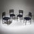 Set of four black-lacquered dining chairs featuring distinctive backrests with looped decoration. Model G6G was designed...