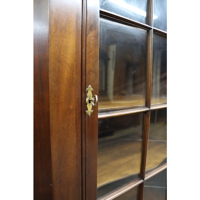 Classic Henkel Harris two-piece mahogany corner cabinet featuring a glazed upper display section with divided-light glass...