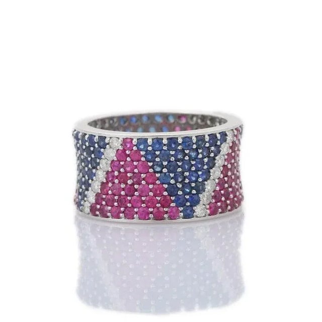This is part of Chairish’s Fine Jewelry assortment. Wide Pave Eternity Ring with Ruby, Sapphire and Diamond in 18k Gold...