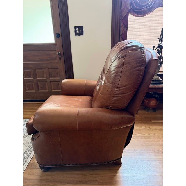 Super comfortable leather recliner chair. In good condition for a previously used chair. SOft brown leather with metal...