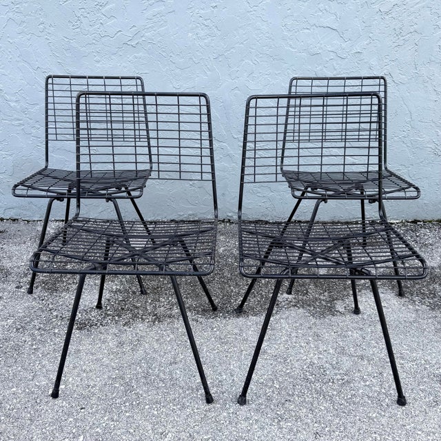 Designed by John Keal for Pacific Iron, this set of four mid-century modern side chairs showcases the airy, architectural...