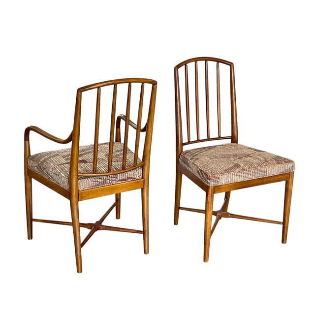 An exceptional set of six mid-century dining chairs, including two armchairs and four side chairs, in the style of Seven...