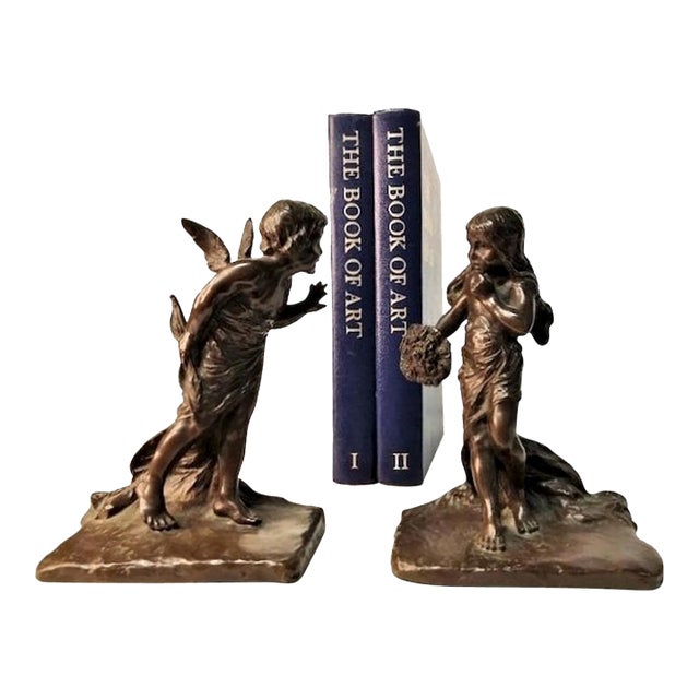 A charming set of bronze bookends. One of the bookends depicts a figure of a young girl with a questioning face...