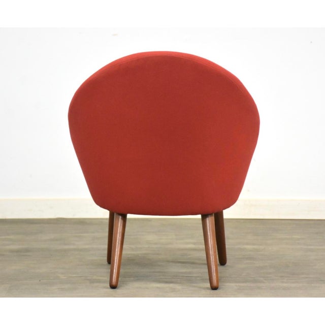 A mid century modern red round back petite lounge chair designed by Ejvind Johansson for Godtfred H. Petersen model 301....