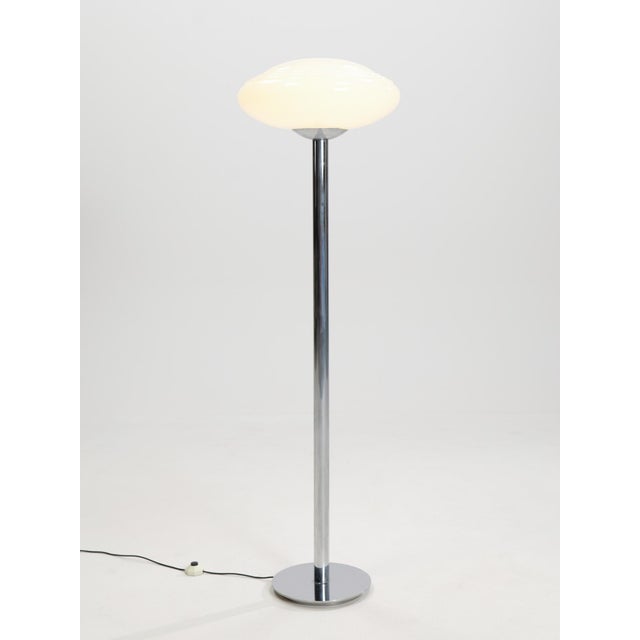 This elegant floor lamp was made in Italy in the 1970s and reflects the refined modernist aesthetic of the period. It...