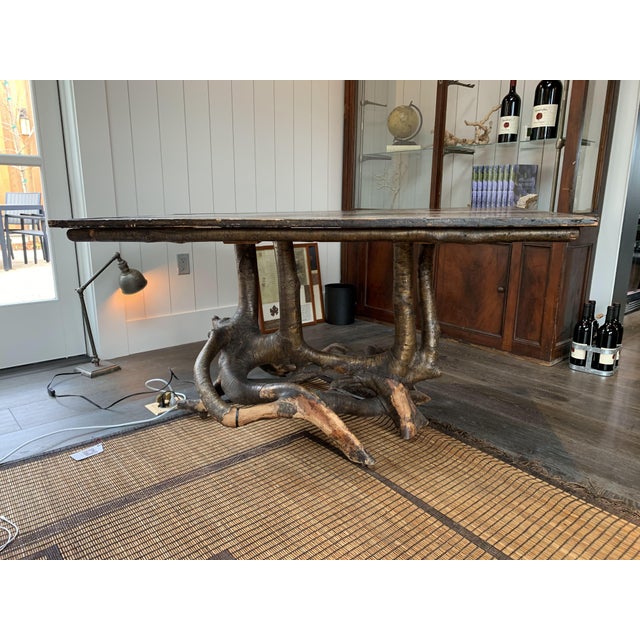 Beautiful rustic wood console table with a very interesting tree branch base.