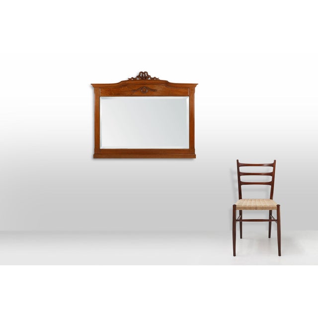 Crafted in France during the 1930s, this elegant wall mirror beautifully bridges the transition between late Art Deco...