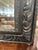 Wide, carved frame with cove toward the back. The mirror is original beveled glass with what appears to be a makers mark...