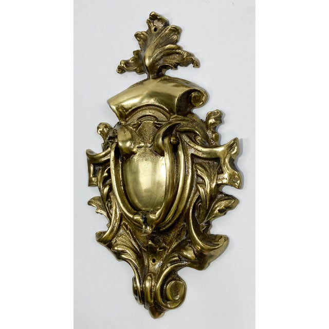 Large vintage lacquered cast brass door knocker with scroll detail. Age wear. Two holes for hanging.