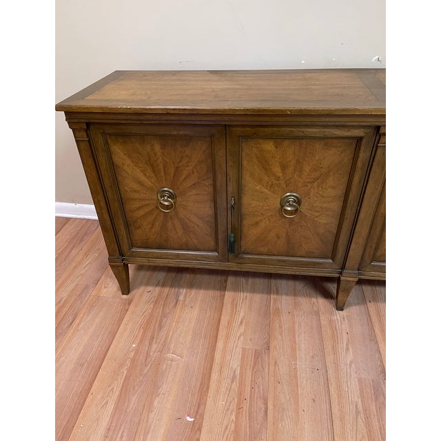 Fine quality Baker Furniture walnut credenza. Made in the 1960s. On the left-hand side, there are 2 pull out drawers...