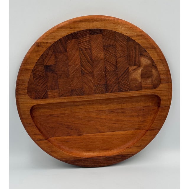 Mid-Century Modern charcuterie board designed by Jens Quistgaard for Dansk, Denmark. This piece is crafted of solid...