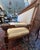 Stunning French hall bench with carvings of lion heads. Crafted of walnut, turn-of-the-century. 68w x 26"d x 50"h