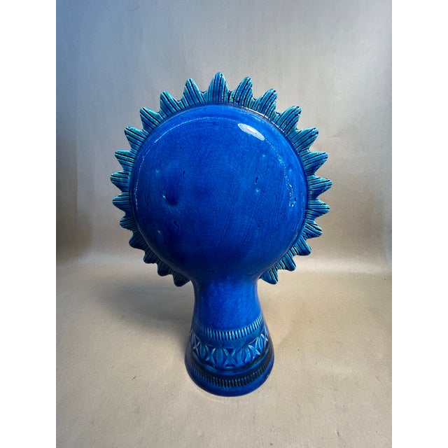 Italian ceramic sun figure from the Bitossi Rimini Blu line. Features a stylized face with radiating sun rays and incised...