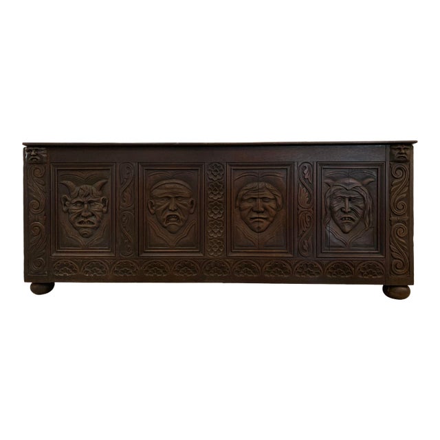 Vintage Medieval Solid Wood Trunk With Carved Faces For Sale