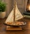 Add a touch of nautical charm and inspirational décor to your home with this **Vintage Wooden Sailboat Yacht Sculpture**,...