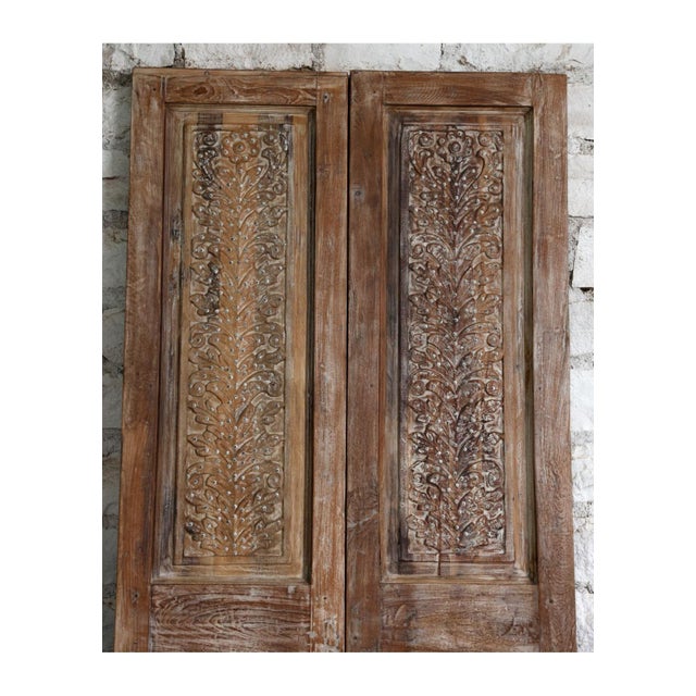 Make a bold architectural statement with this exquisite pair of vintage carved double doors, adorned with traditional...
