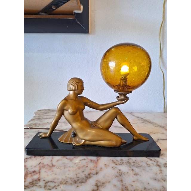 An Art Deco spelter lady lamp, circa 1930, Germany. One of a kind with art glass. Length 14.5" x Height 12". Wear and tear...
