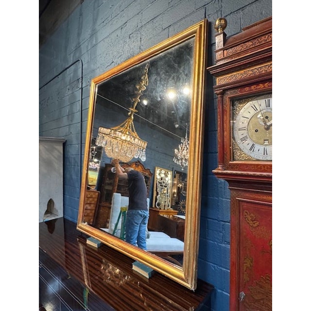 The 19th Century French Transitional Gold Gilt Mirror exudes a sense of elegance and simplicity. This mirror features...