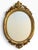A spectacular vintage Italian oval wall mirror by Euromarchi S.r.L., featuring an elaborately sculpted gilt-gold frame...