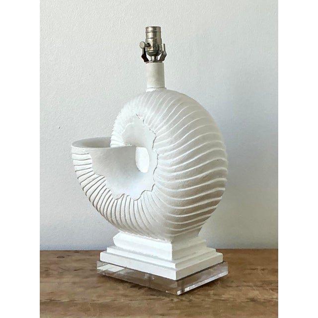 This striking vintage table lamp is a masterclass in Postmodern Coastal design, featuring a large, sculptural nautilus...