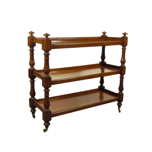 A 19th-C. English William IV three tier mahogany dumb waiter with original brass and porcelain wheel casters and rich...