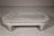 A teak wood vintage whitewash low coffee table with oval top and simply carved legs. Born from vintage charm, this...